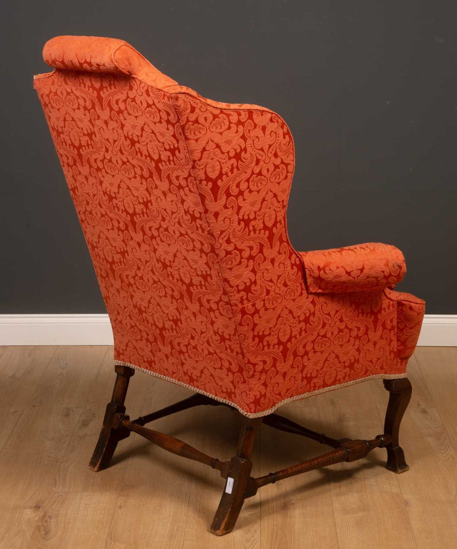 A Georgian mahogany high wingback armchair on scrolling supports united by an H-frame stretcher, - Image 4 of 5