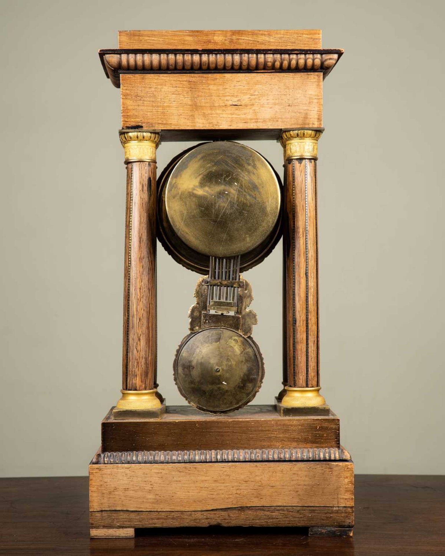 A French walnut portico clock with brass and mother of pearl decoration, the white enamel dial - Image 3 of 3