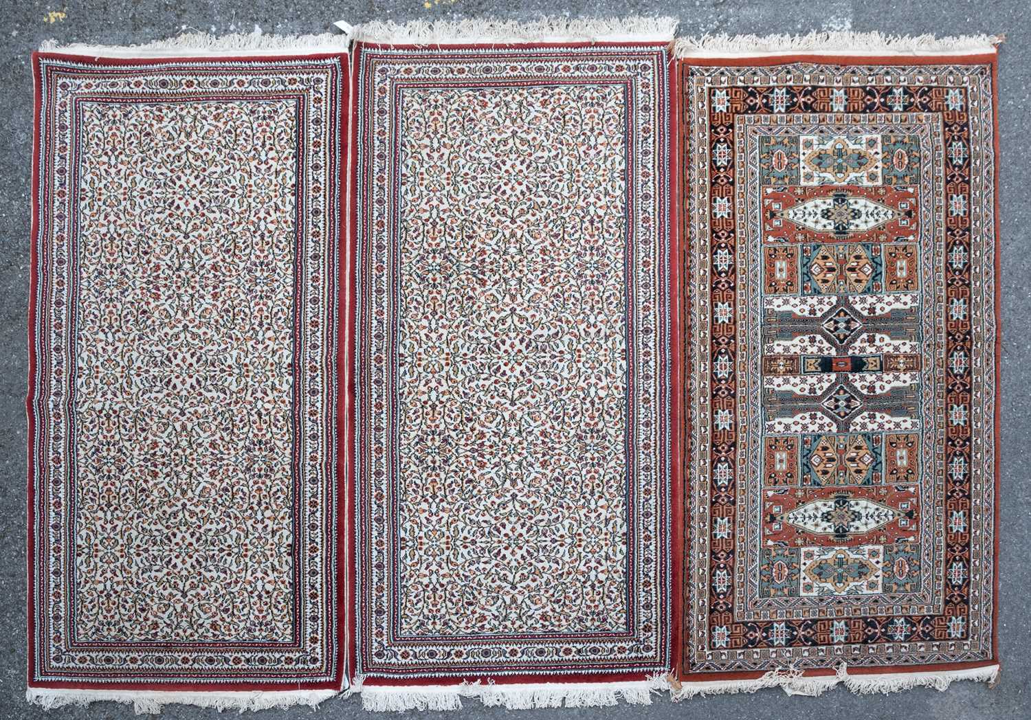 Three decorative machine made rugs all 99cm x 200cmModerate to good condition, with some minor wear