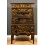 An 18th century and later black lacquer chinoiserie decorated chest on stand, decorated with