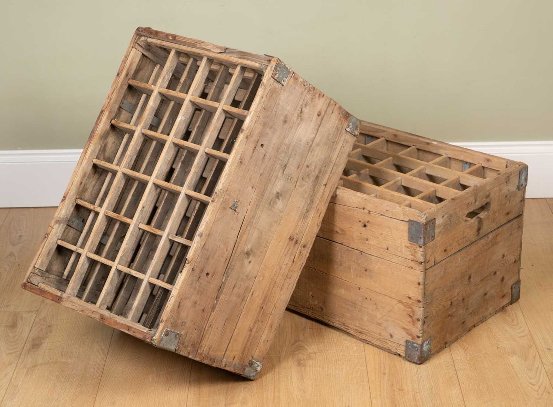 A pair of wooden bottle crates of plank construction, each with twenty four bottle slots, 62cm