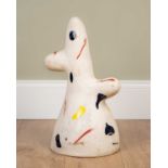 An abstract ceramic sculpture, with splashes of coloured glaze in blues, yellows and red,