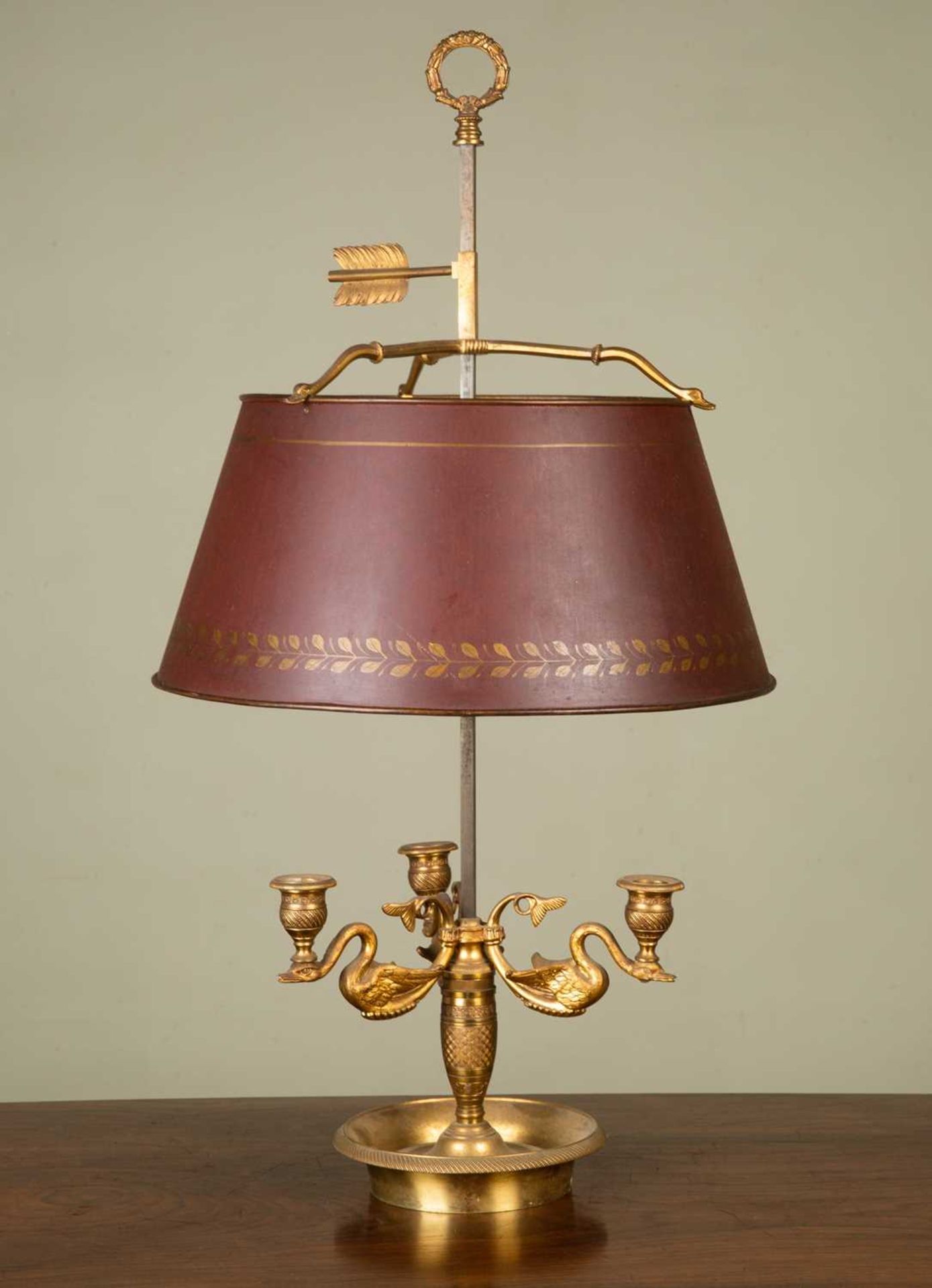 An antique ormolu bouillotte table lamp, the three branches cast in the form of swans on a