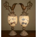 A pair of 19th century porcelain and metal ewers, the porcelain body decorated with blue and white