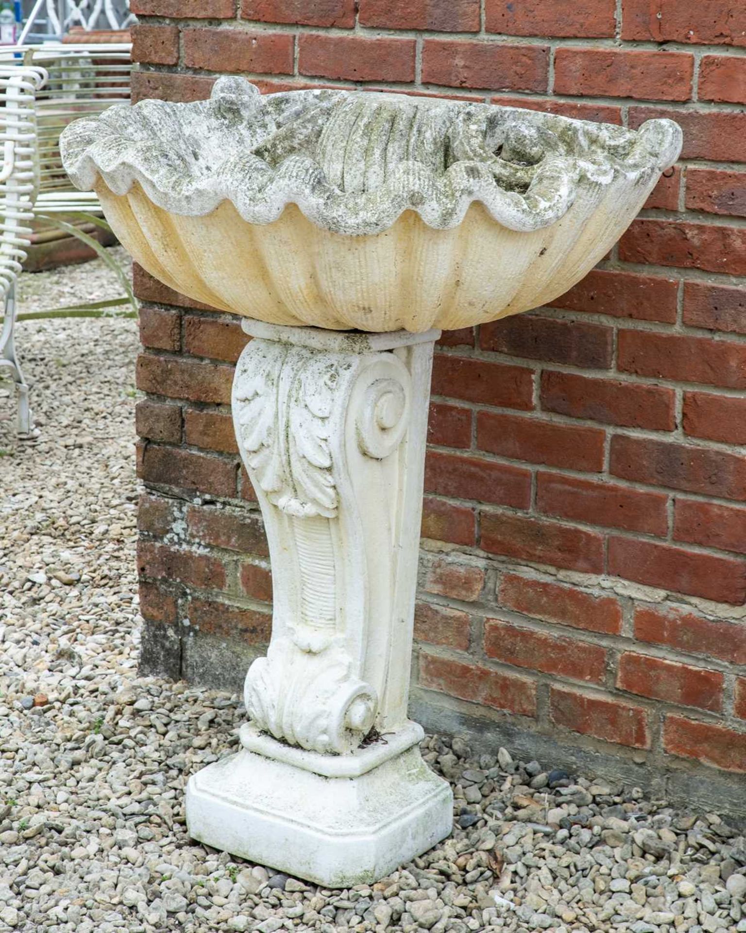 A cast reconstituted stone wall fountain in the form of a large shell on supporting pedestal with - Image 2 of 3