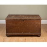 A Victorian scumbled pine blanket box, the lid opening to reveal a plain interior with lidded candle