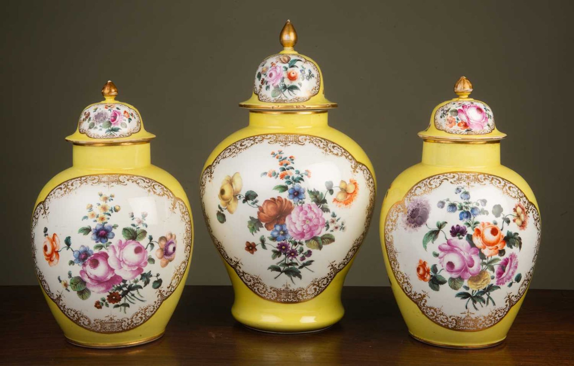 A garniture of three Dresden yellow ground ovoid vases and covers decorated to one side with - Image 2 of 4
