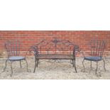 A black painted wrought iron garden seat, with scroll ornament to the back and arms, 141cm wide,