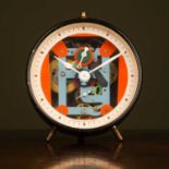 A Liberty of London vintage alarm clock with exposed multicoloured working within black case, 10cm