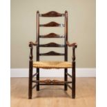 An ash framed ladder back chair with rush seat, stamped 'WA' to the seat back, on turned supports,