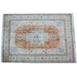 A large orange and cream ground Middle Eastern woollen carpet 408cm x 314cmSome patches of wear