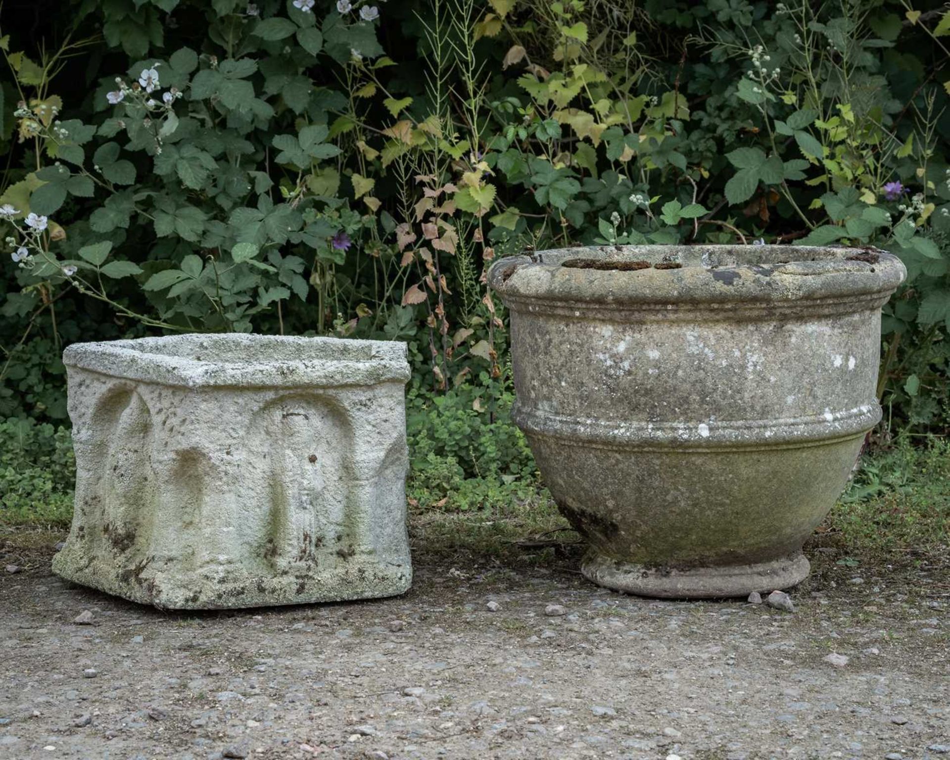 A circular cast reconstituted stone garden planter with banded ornament, 53cm diameter x 43cm
