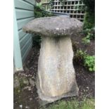 An old carved staddle stone with circular top and square spreading base, 47cm diameter,