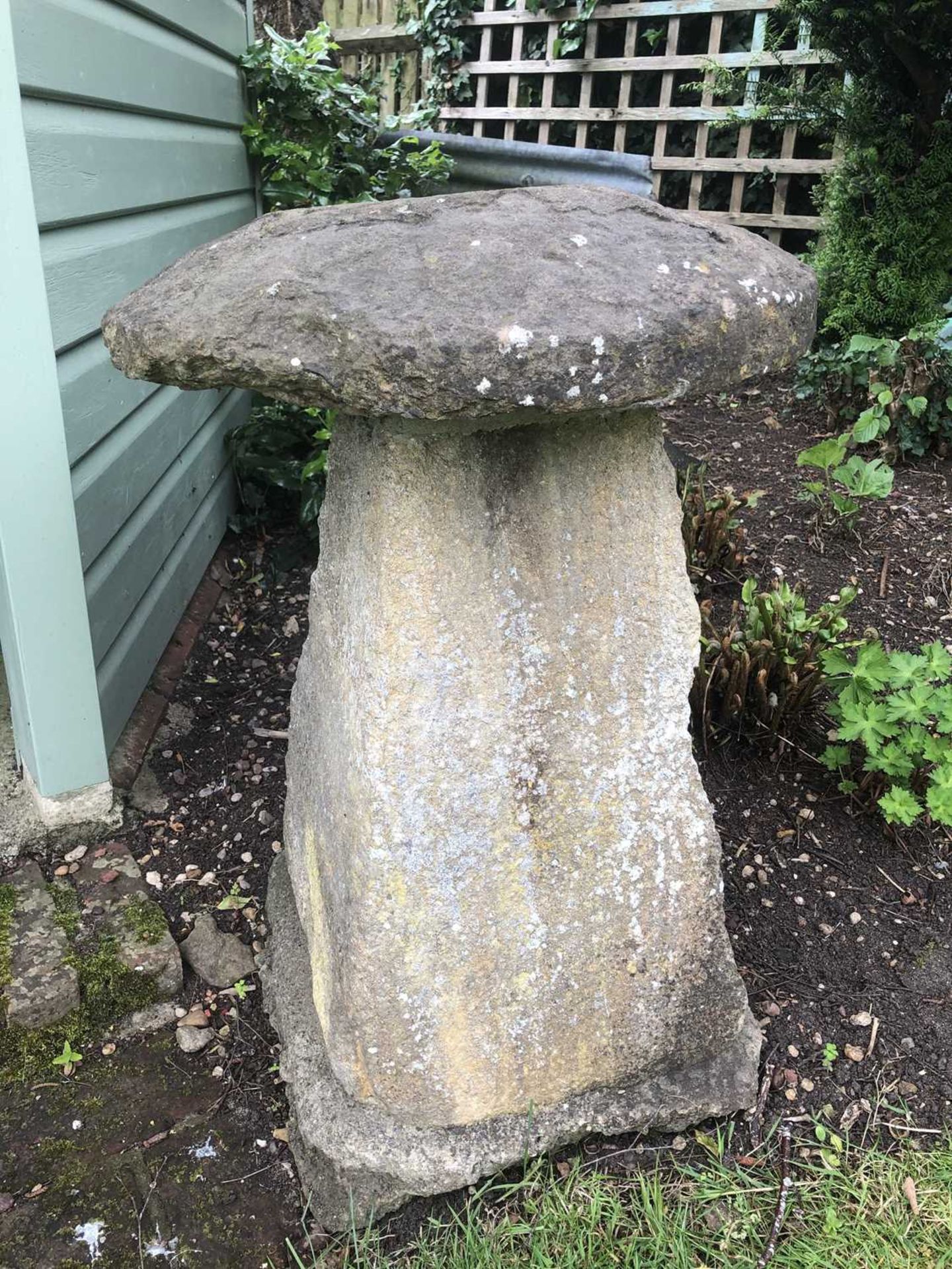 An old carved staddle stone with circular top and square spreading base, 47cm diameter,