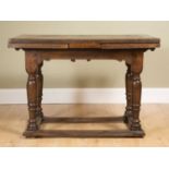 A James I style oak draw leaf dining table, with rectangular top over turned legs united by