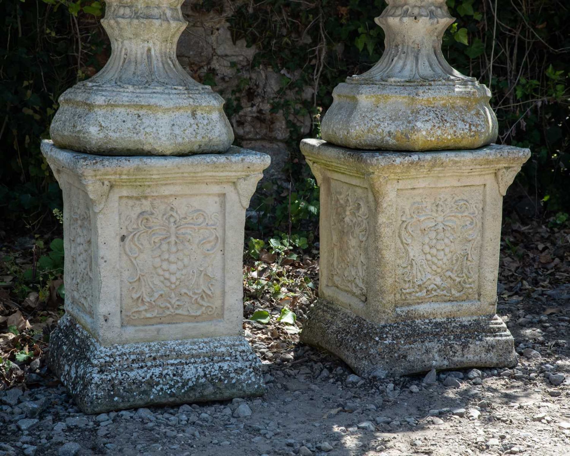 A pair of cast reconstituted stone garden urns decorated with acanthus leaves on octagonal bases and - Image 4 of 4