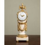 An early 20th century French ormolu and marble timepiece in the Classical style, with flaming vase