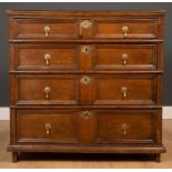 A late 17th / early 18th century oak chest of four long graduated drawers with drop handles and