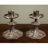 A pair of antique silver plated octagonal candlesticks of squat form, 15.5cm wide, 20cm highWear