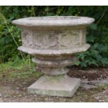 A cast reconstituted stone Haddonstone octagonal planter in the form of a font, with quatrefoil
