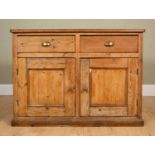 A pine side cabinet the pair of doors over pair of cupboard doors opening to reveal two shelves,