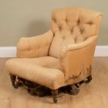 An antique Howard & Sons Ltd armchair with buttoned upholstered back and arms, all four castors