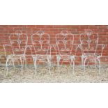 A set of four white painted wirework garden armchairs, 46cm wide, 97cm highIn need of replacement
