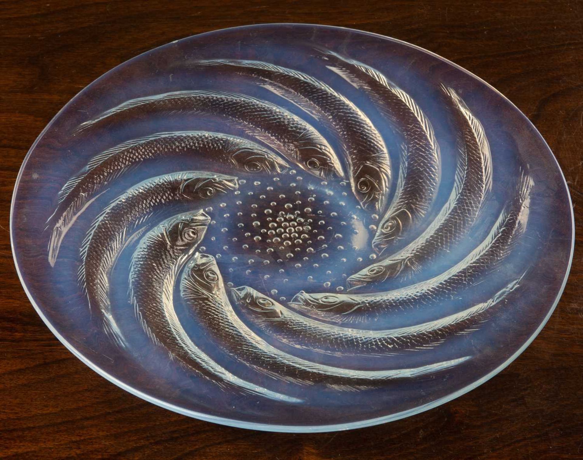 A Lalique glass opalescent poisson plate, signed to the centre 'R. Lalique', 27cm diameterTiny