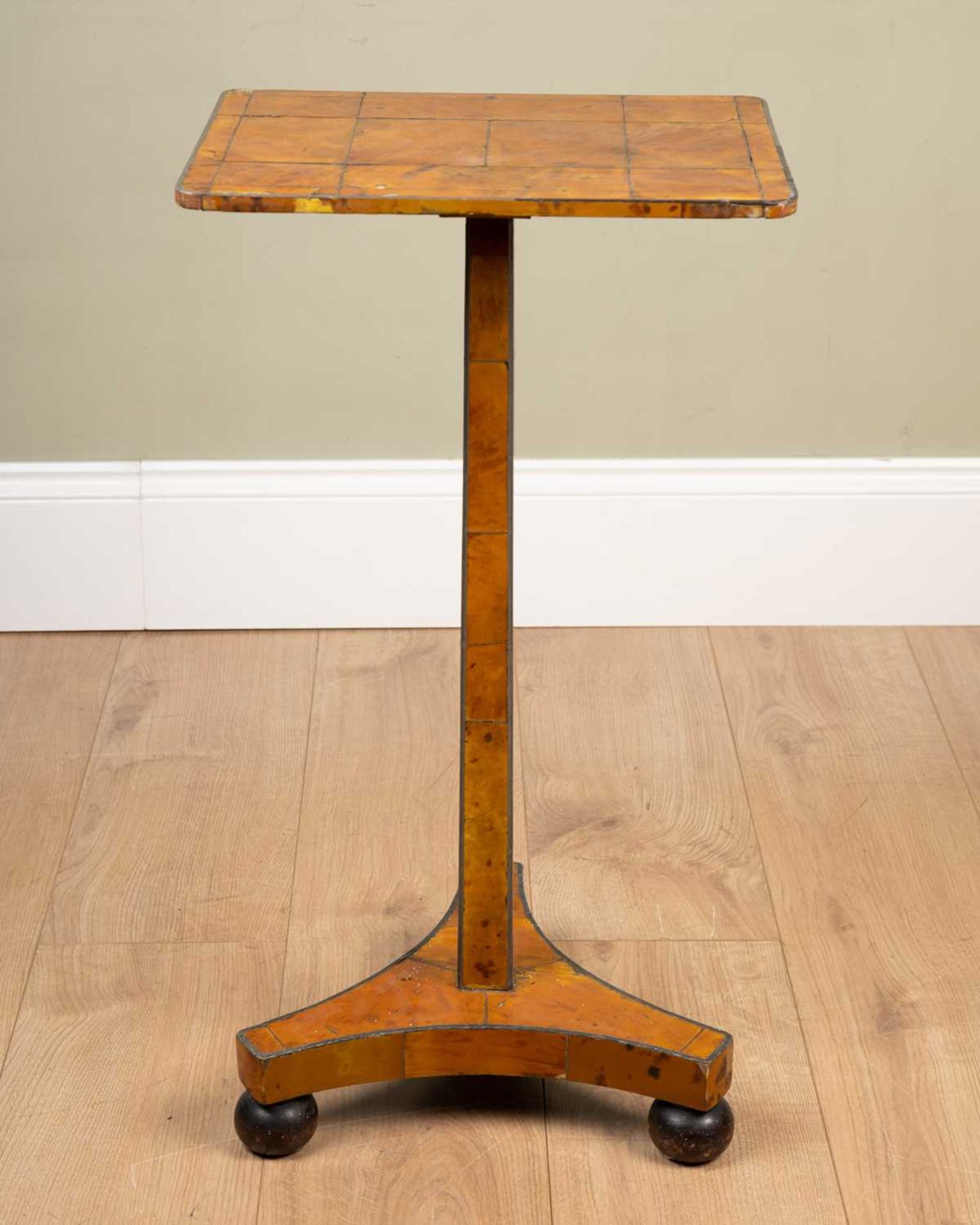 A tortoiseshell veneered wine table, the square metal inlaid top on tapering support and triform