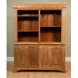 A pine dresser with adjustable shelves over two pairs of cupboard doors, all on bracket feet,
