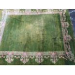 An antique green ground Turkey carpet, with Arts and Crafts style floral border, and with old