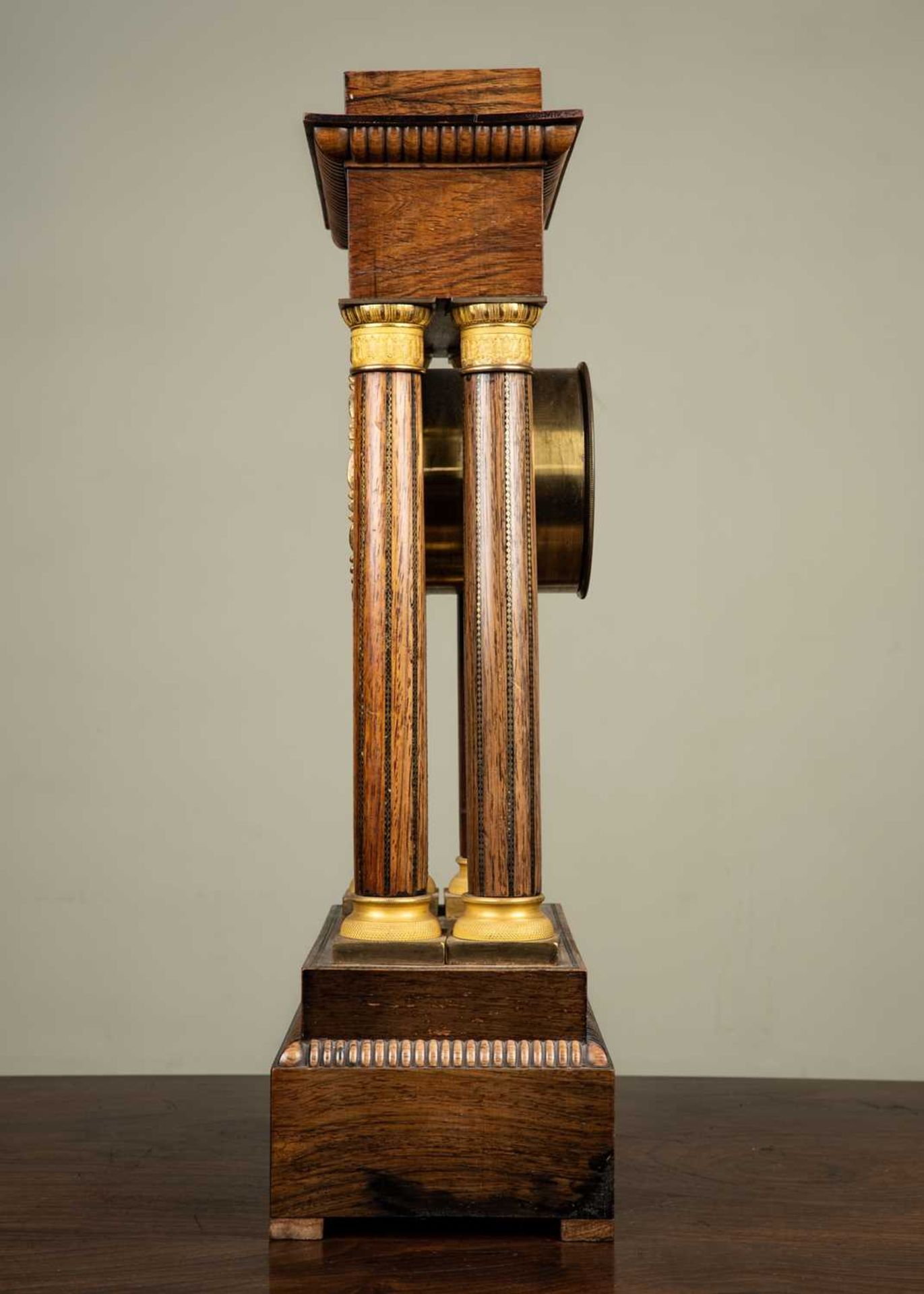 A French walnut portico clock with brass and mother of pearl decoration, the white enamel dial - Image 2 of 3