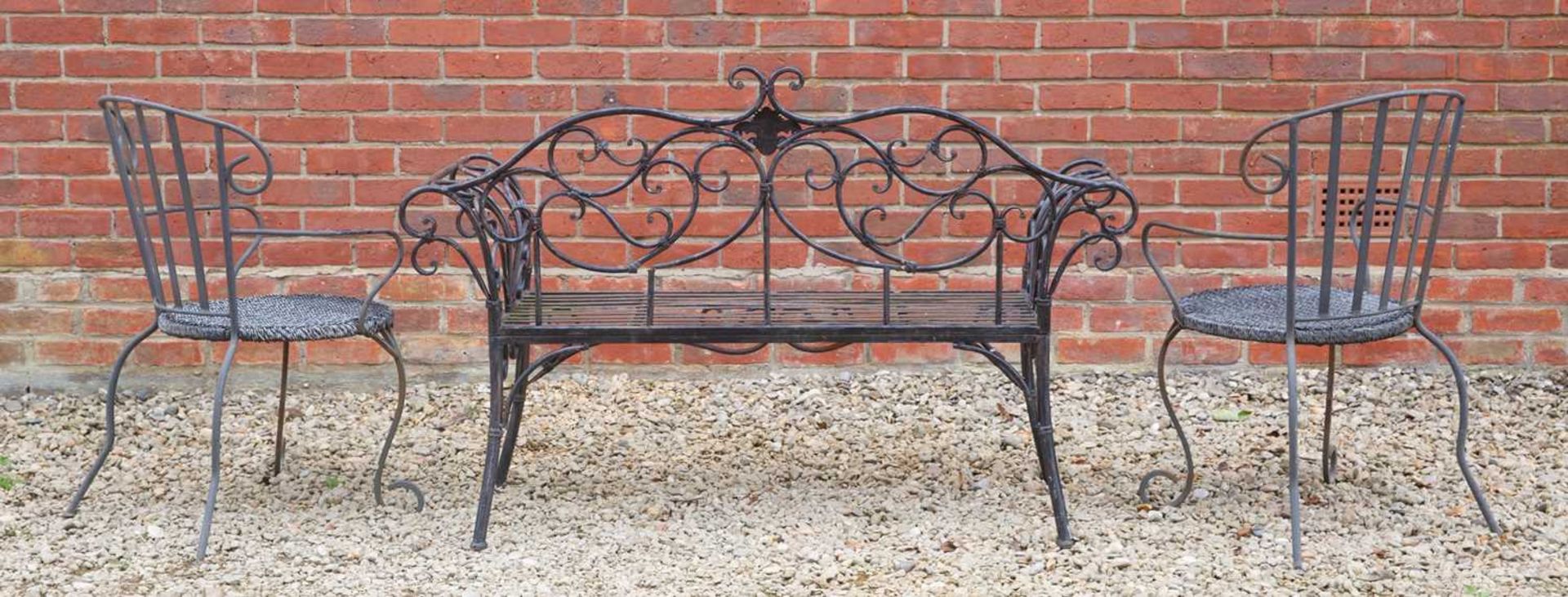A black painted wrought iron garden seat, with scroll ornament to the back and arms, 141cm wide, - Image 2 of 3