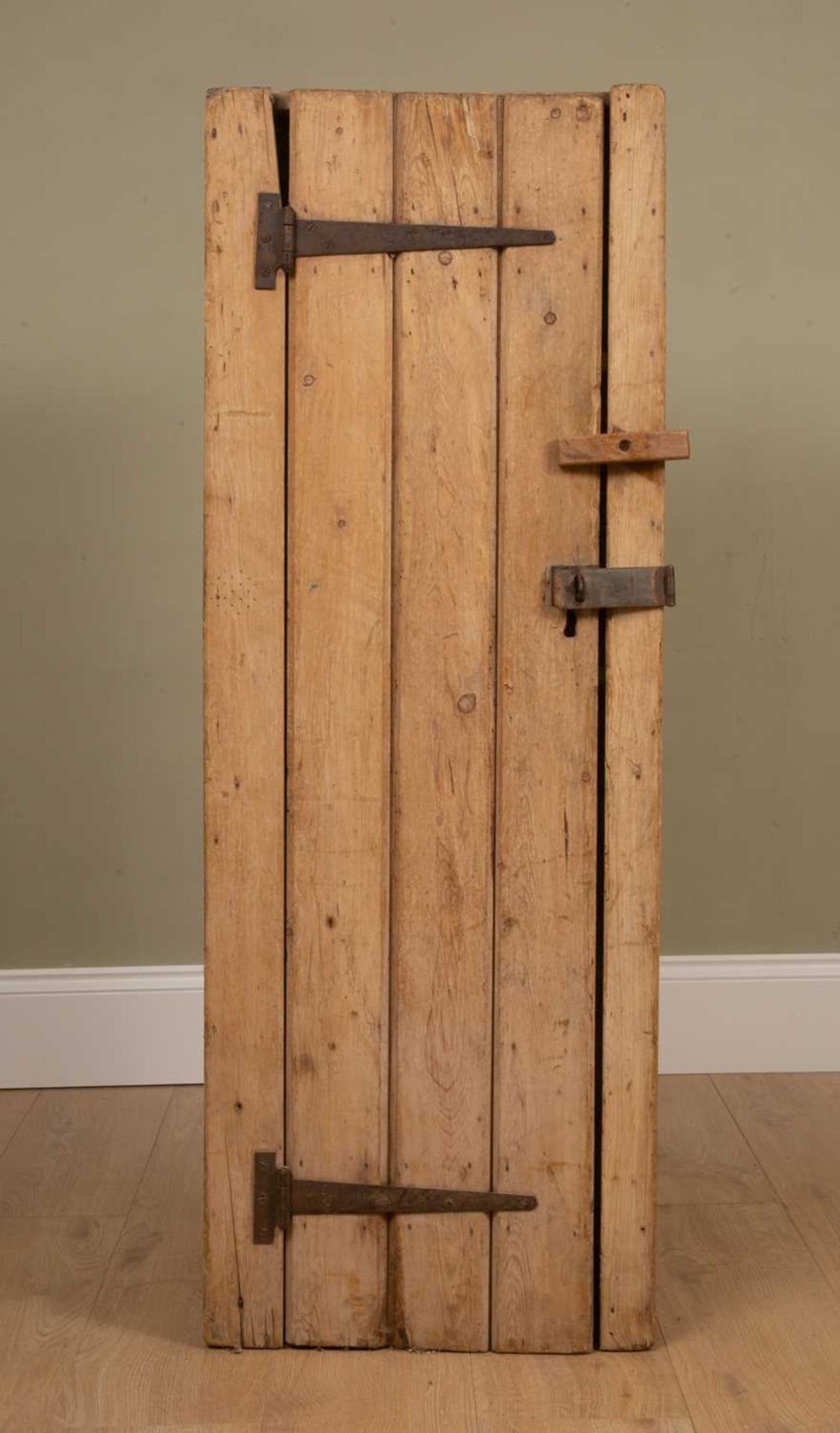 A rustic pine cupboard with iron hinges and lock plate, 44cm wide x 38.5cm deep x 123cm highDents,
