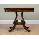 A Victorian rosewood fold over tea table, with brass inlay on scrolling supports, trestle base and
