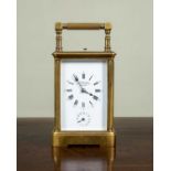 A French brass cased carriage clock retailed by J. W. Benson, 28 Royal Exchange, with platform