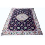 A large hand woven needlepoint carpet with a cream border and a black central ground, having