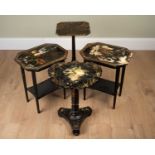 A pair of black lacquer occasional tables, the tops painted with fruit motifs within a gold border