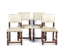 In the manner of Heals Set of four limed oak chairs, with cream upholstery and studded detail,