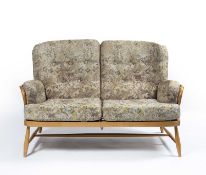 Ercol light elm sofa, with floral upholstered cushions, with Ercol circular label to the