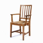 Arts and Crafts Oak, elbow or armchair with rush seat, the back rail carved 'D & F Davies',