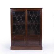 Attributed to Heals mahogany glazed bookcase, 104cm x 137.5cm x 33cm approx overall Information: See