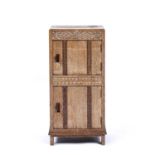 Kean and Scott of Birmingham Limed oak small cupboard, with panelled and carved front, label to