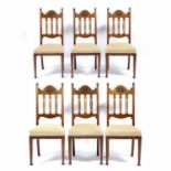 Arts and Crafts Set of six dining walnut chairs, carved top rail and pierced shaped splats with
