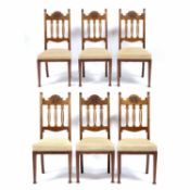 Arts and Crafts Set of six dining walnut chairs, carved top rail and pierced shaped splats with