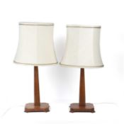 Cotswold School pair of table lamps, oak, with cream coloured shades, 39cm high including the