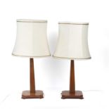 Cotswold School pair of table lamps, oak, with cream coloured shades, 39cm high including the