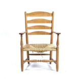 After Ernest Gimson (1864-1912) Oak, 'Clissett' style armchair of small proportions, with rush seat,