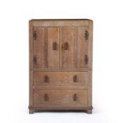 Attributed to Kean & Scott of Birmingham Limed oak cupboard, with carved decoration, 77cm x 114cm