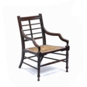 In the Manner of Edward William Godwin (1833-1886) Elbow chair with raffia seat, aesthetic movement,